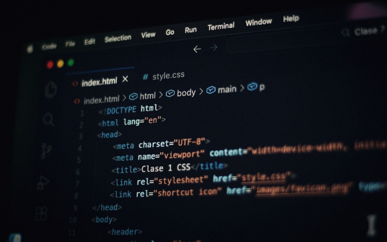 Screen displaying HTML code with tags for doctype, head, and stylesheet links in an editor