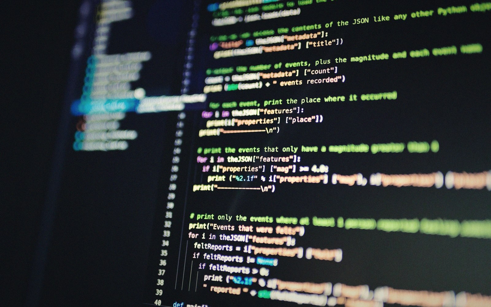Python code on a screen displaying JSON parsing logic for earthquake event data