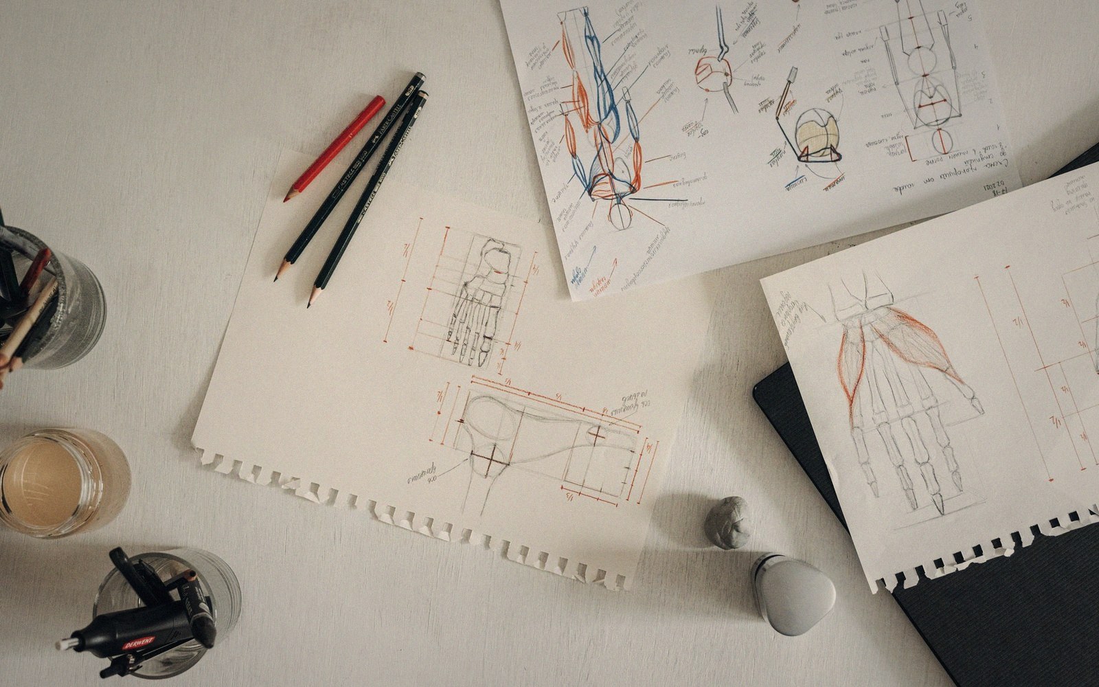 A wall of printed level plans marked in pen