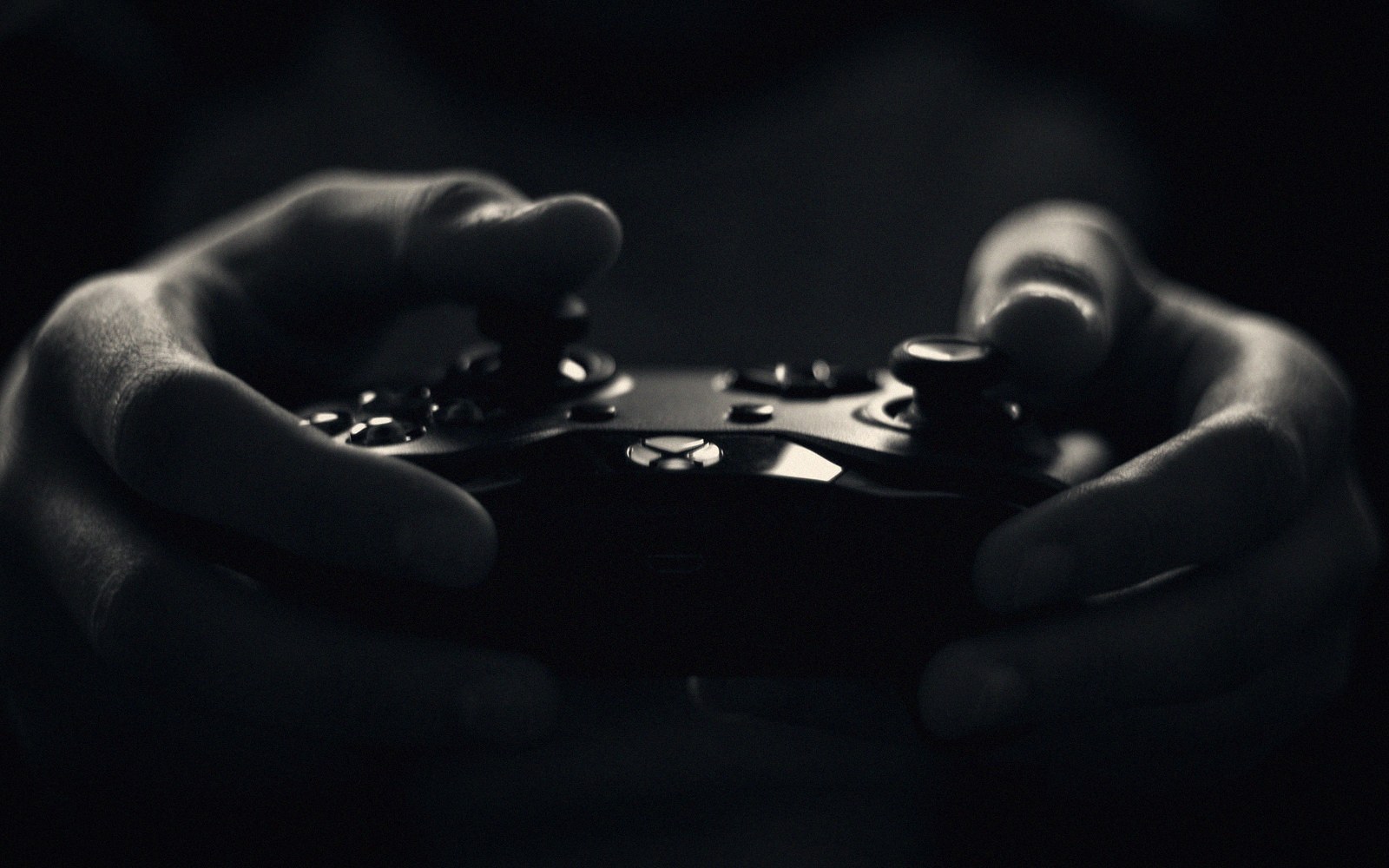 Hands on a controller in a test booth, debug overlay on screen